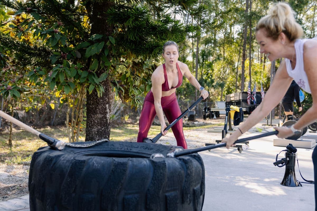 Client flipping the tire at a Shred Shed event