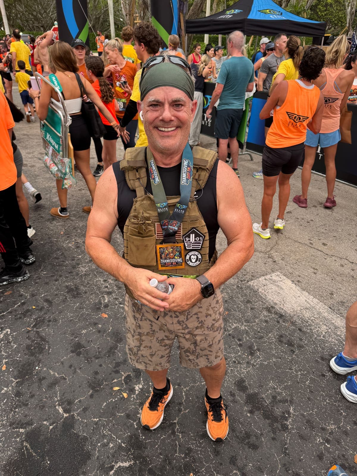 The founder wearing his medal and weighted vest after finishing Hyrox