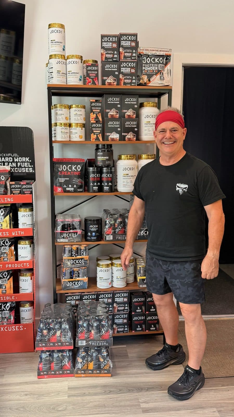 Jim beside the fuel and supplement shelf at The Shred Shed