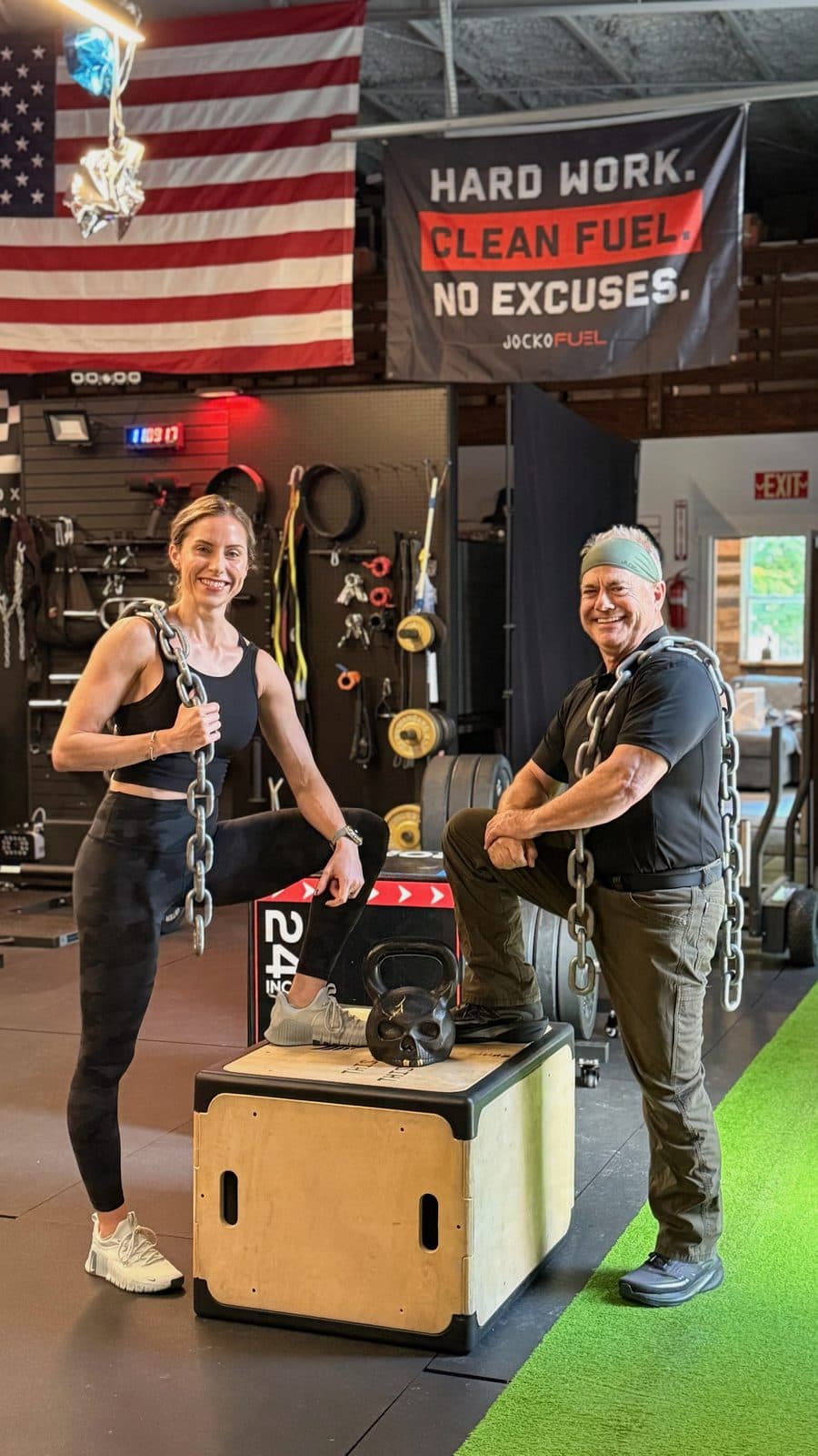 Coaches Lara and Jim at The Shred Shed, chains over their shoulders