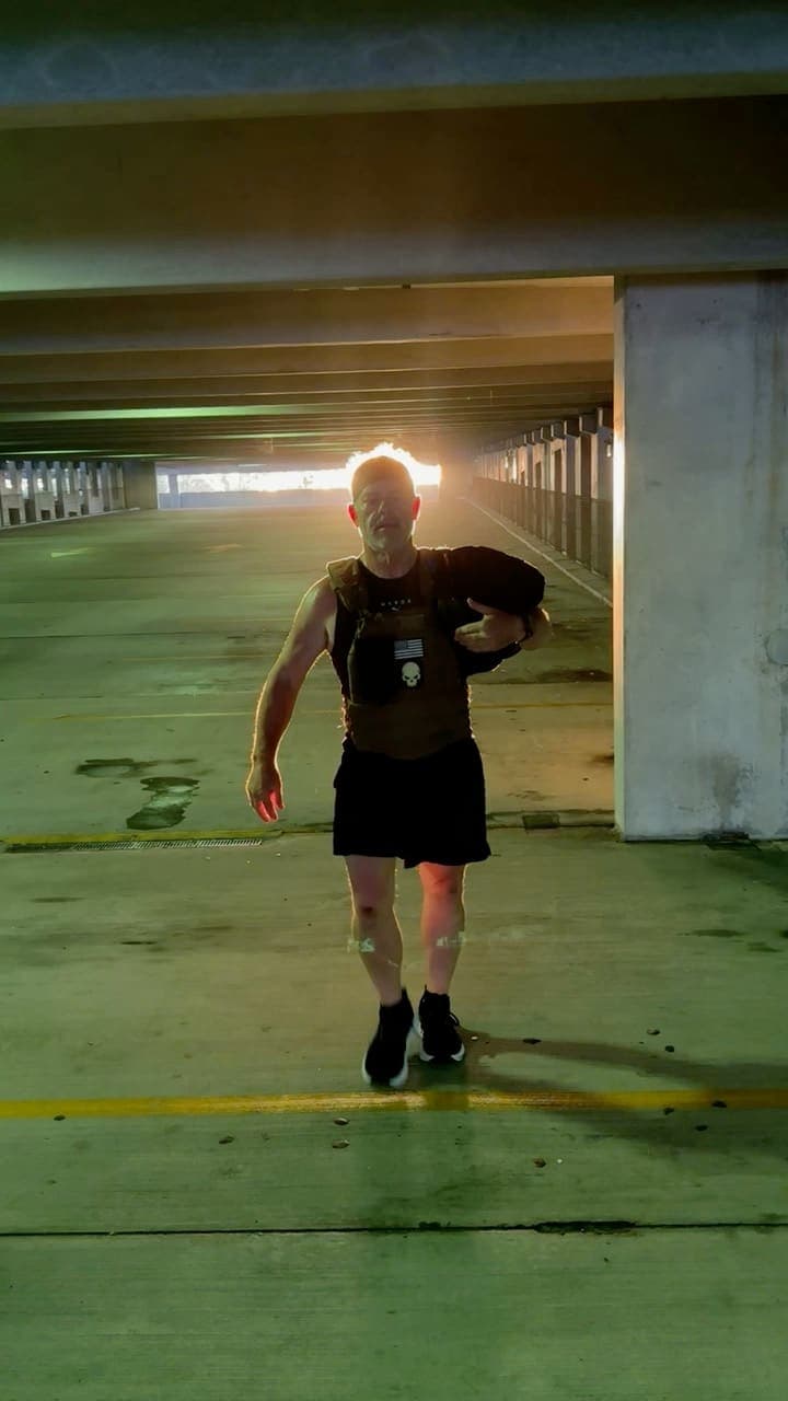 Weighted-vest training session on the road — the program travels with you
